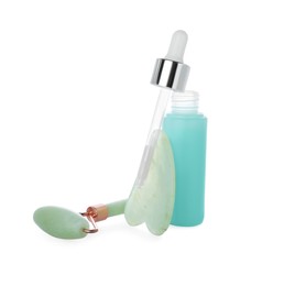 Jade gua sha tool, facial roller and bottle of serum isolated on white