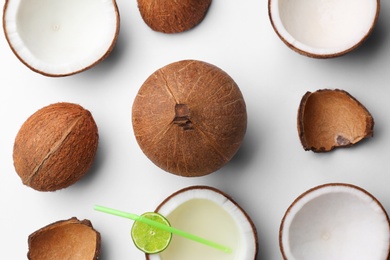 Composition with coconuts and drink on white background, top view