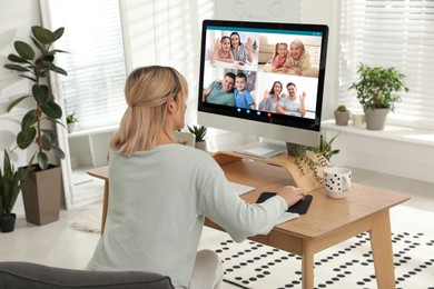 Woman having online meeting with family members via videocall application at home