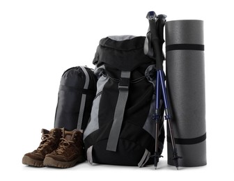 Photo of Pair of trekking poles and camping equipment for tourism on white background