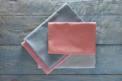 Different colorful napkins on wooden table, top view