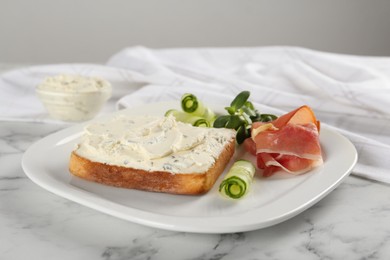 Photo of Delicious sandwich with cream cheese, cucumber and jamon on white marble table