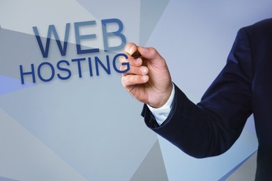 Businessman pointing at phrase WEB HOSTING on virtual screen against color background, closeup