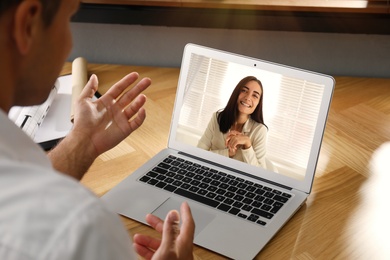 Coworkers working together online. Man using video chat on laptop, closeup