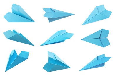 Set with handmade light blue paper planes on white background