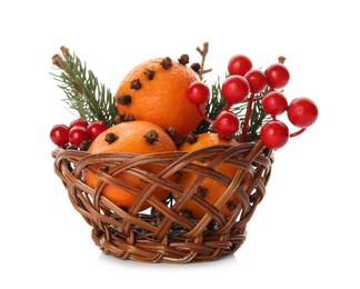 Photo of Christmas composition with tangerine pomander balls in wicker bowl isolated on white