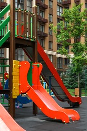Photo of Empty outdoor children's playground with slides in residential area