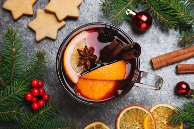 Flat lay composition with aromatic mulled wine on grey table, closeup