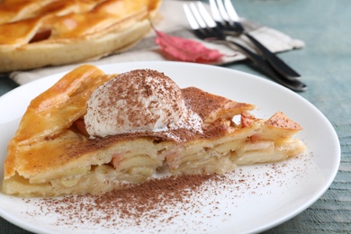 Photo of Slice of traditional apple pie with ice cream on plate, closeup