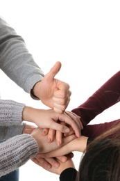 Young people putting their hands together on white background, closeup