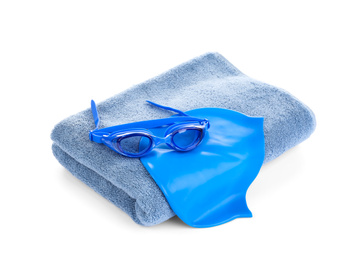 Swimming cap, goggles and towel isolated on white