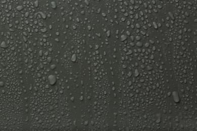 Photo of Many water drops on dark grey background