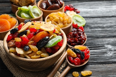 Composition with different dried fruits on wooden background, space for text. Healthy lifestyle