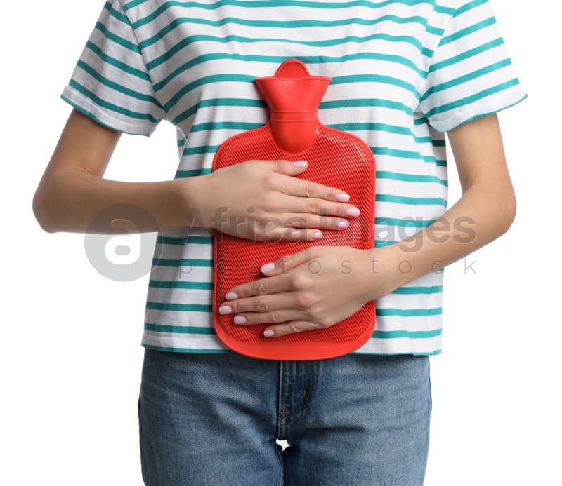 Woman using hot water bottle to relieve abdominal pain on white background, closeup