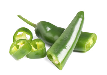 Photo of Cut green hot chili peppers on white background