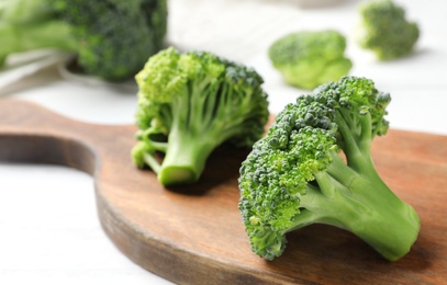 Board with fresh green broccoli on table, closeup