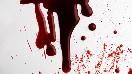 Stain and splashes of blood on light grey background