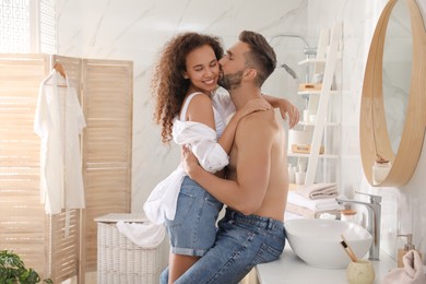 Lovely couple enjoying each other in bathroom at home
