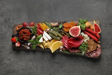 Set of different delicious appetizers served on grey table, top view