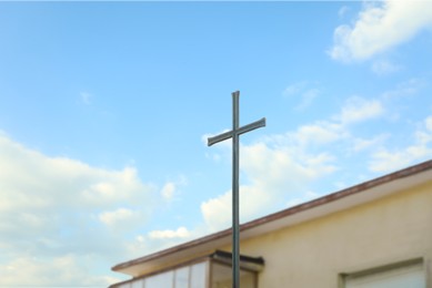 Metal Christian cross outdoors on sunny day