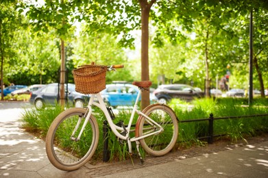 Beautiful bike with basket on sunny day outdoors