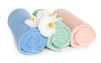 Clean soft towels with orchids isolated on white