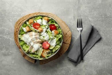 Delicious salad with Chinese cabbage, cucumber, meat and tomatoes served on grey table, flat lay