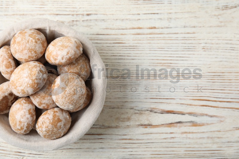 Photo of Tasty homemade gingerbread cookies on white wooden table, top view. Space for text