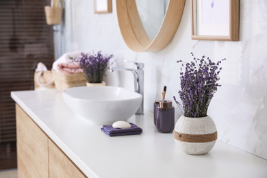 Vase with dried lavender flowers on bathroom counter. Interior design
