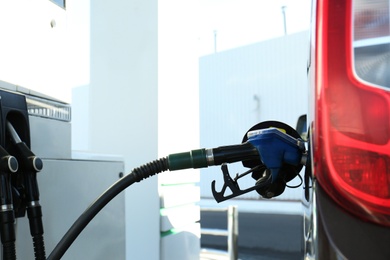 Modern car refilling with fuel at gas station