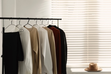 Rack with stylish men's clothes indoors. Interior design