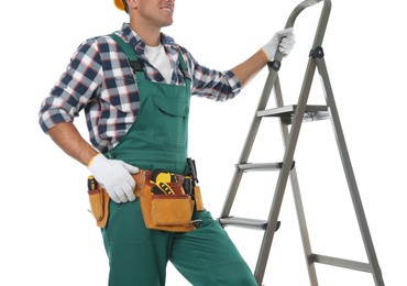 Professional builder near metal ladder on white background, closeup