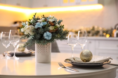 Beautiful winter bouquet on white table in kitchen