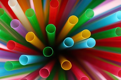 Heap of colorful plastic straws for drinks as background, closeup