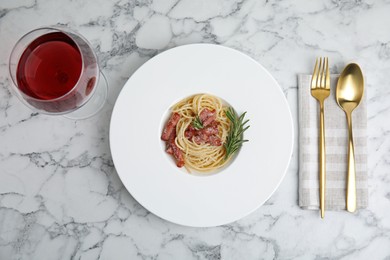 Delicious Carbonara pasta served on white marble table, flat lay