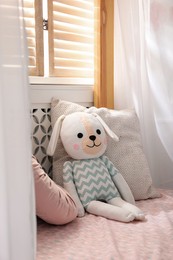 Toy dog on bed in child's room