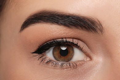 Photo of Beautiful woman with black eyeliner, closeup view
