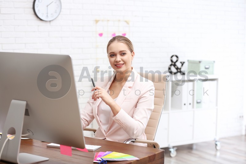 Female designer working at desk in office