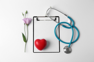 Photo of Composition with stethoscope and flower on white background. World health day