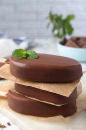 Delicious glazed ice cream bars with mint on board, closeup