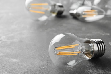 Vintage lamp bulb on grey background. Space for text