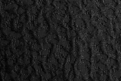 Textured dark fabric as background, closeup view