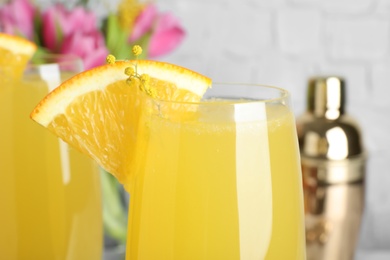 Glass of Mimosa cocktail with garnish, closeup