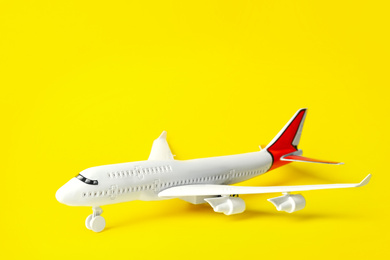 Toy plane  on yellow background, space for text. Logistics and wholesale concept