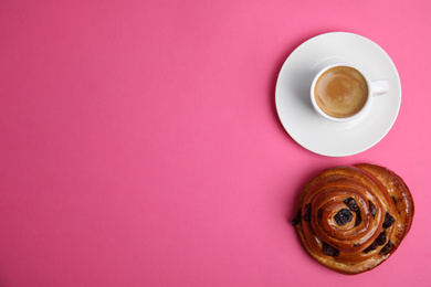 Delicious coffee and bun on pink background, top view with space for text. Sweet pastries