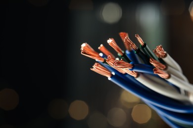 Photo of Stranded copper wires with insulation against blurred background, closeup. Space for text