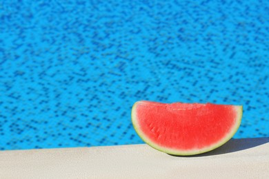 Slice of fresh juicy watermelon near swimming pool outdoors, space for text