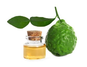 Bottle of essential oil and fresh bergamot fruit on white background