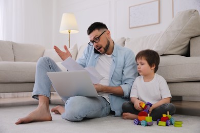 Multitasking man combining parenting and work at home