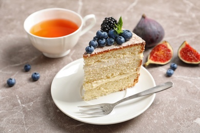 Piece of delicious homemade cake with fresh berries served on table